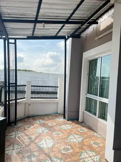Charming balcony with decorative tiles and partial roof, perfect for relaxation.