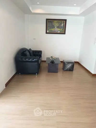 Spacious living room with elegant black sofa and modern decor