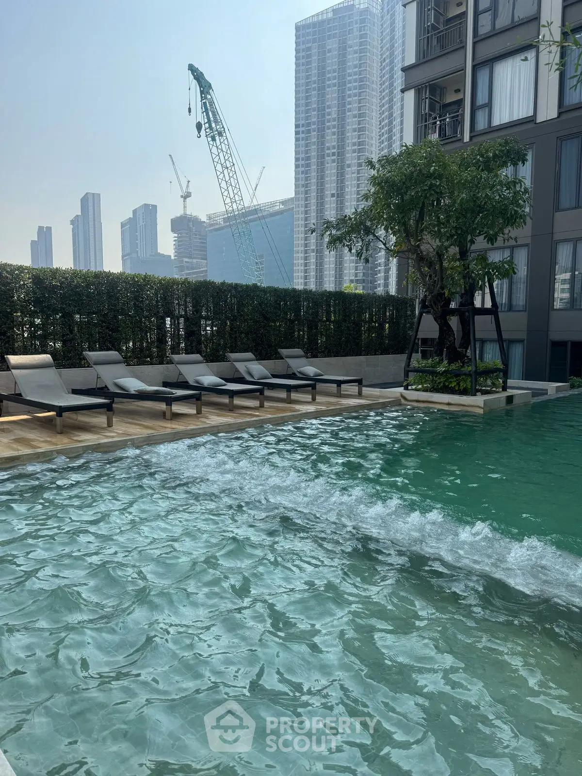Luxurious urban condo with stunning pool and city skyline view.