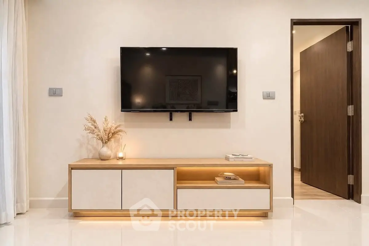 Modern living room with wall-mounted TV and stylish wooden cabinet