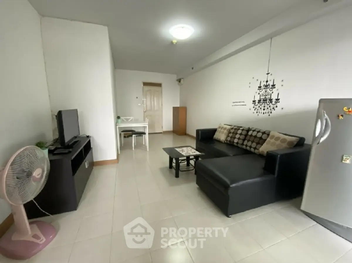 Spacious living room with modern furniture and TV setup