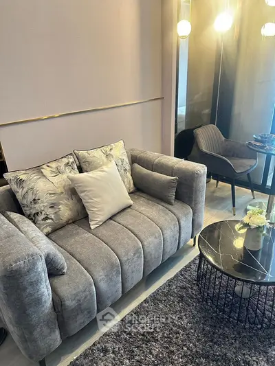 Modern living room with plush gray sofa and stylish decor