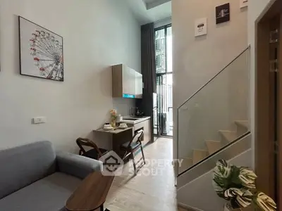 Modern duplex apartment with stylish kitchen and cozy living area, featuring high ceilings and natural light.