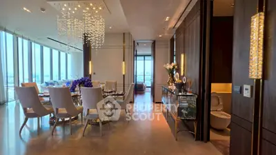 Luxurious dining room with elegant chandelier and panoramic city views in a high-end apartment.