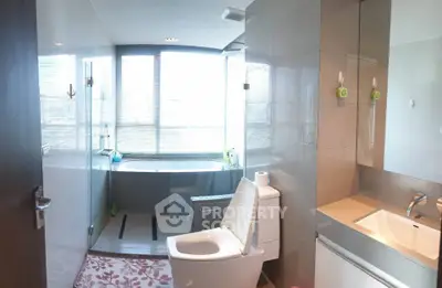 Modern bathroom with large window and bathtub, featuring sleek fixtures and ample natural light.