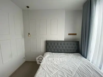 Modern bedroom with elegant tufted headboard and soft natural lighting