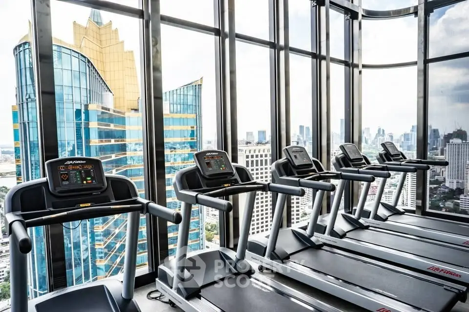 Modern gym with panoramic city views and state-of-the-art equipment in a luxury high-rise building.