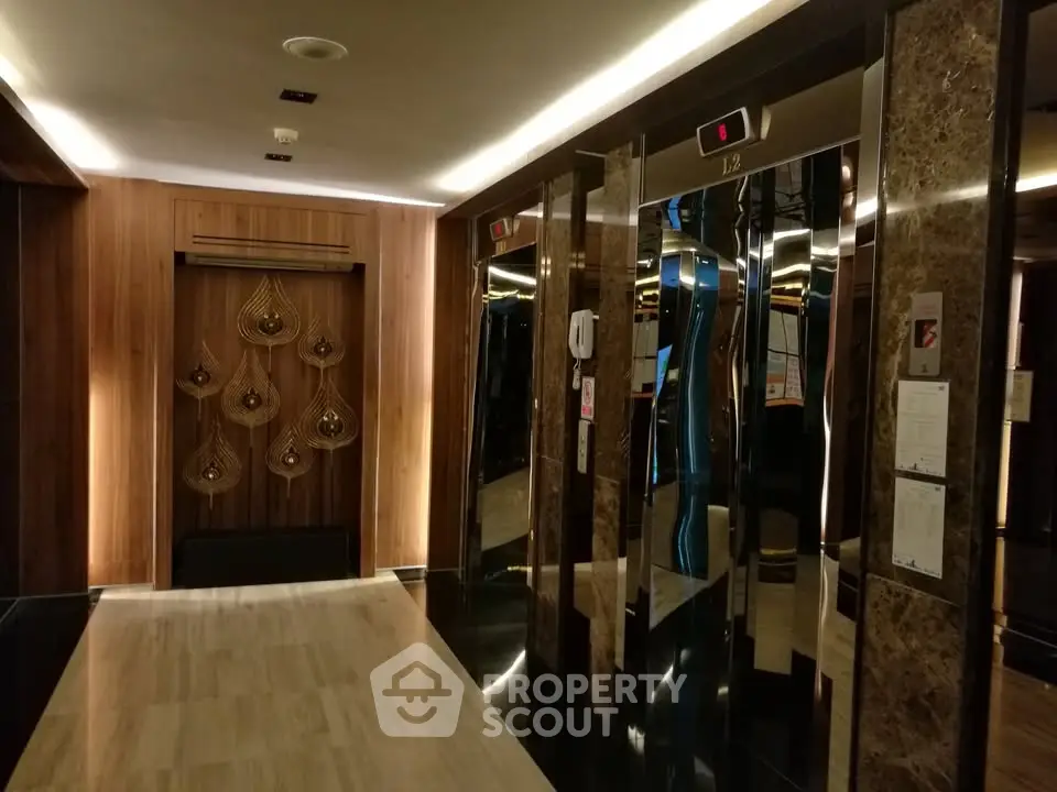 Luxurious modern elevator lobby with elegant wood paneling and ambient lighting
