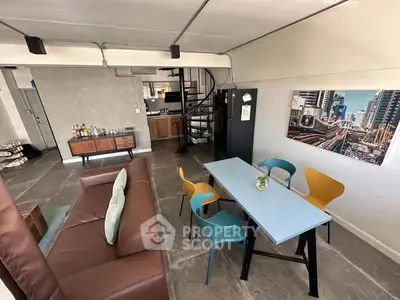 Stylish open-plan living room with modern furniture and urban artwork