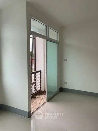 Bright room with sliding glass door leading to a small balcony, perfect for natural light and fresh air.