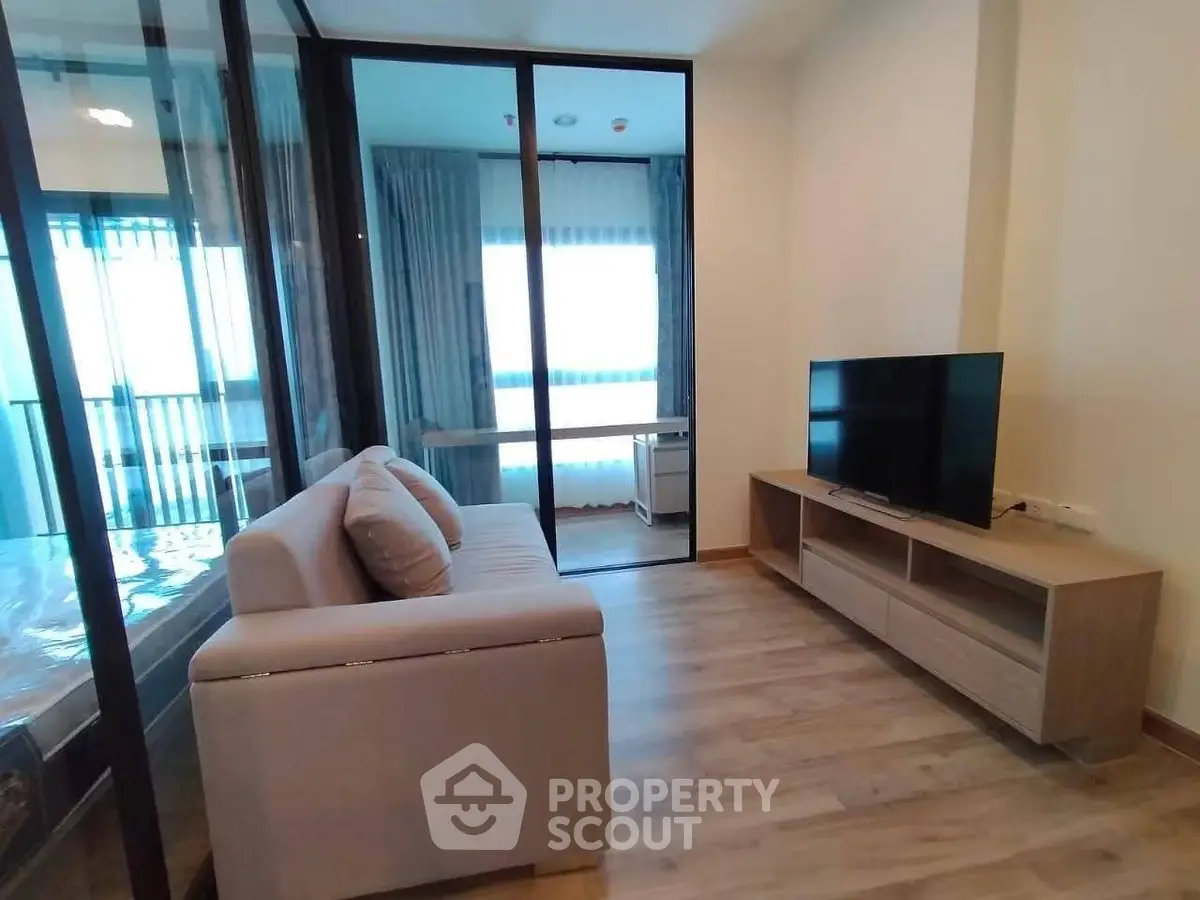 Modern living room with sleek design and large window for natural light