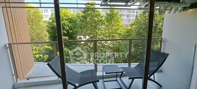 Charming balcony with lush green view and modern seating, perfect for relaxation.
