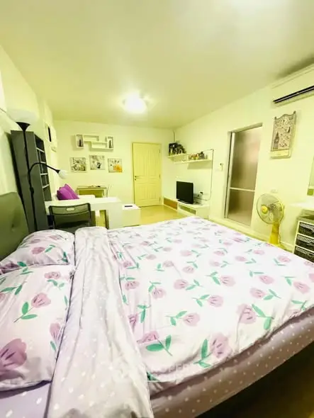 Spacious bedroom with floral bedding and modern decor