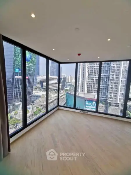 Spacious corner unit with floor-to-ceiling windows offering stunning city views in a modern high-rise building.