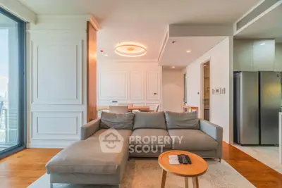 Luxurious modern living room with elegant decor and open layout, featuring a plush sectional sofa and stylish dining area.