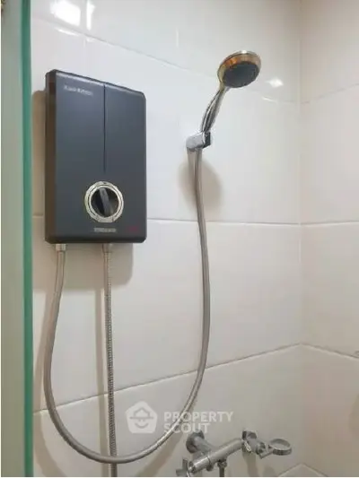 Modern bathroom shower with sleek water heater and tiled wall