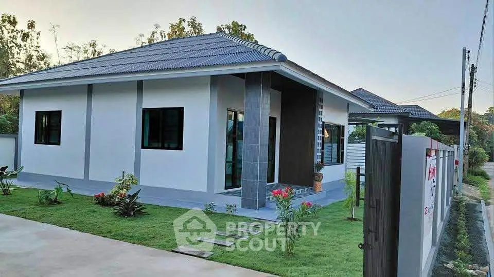 Charming modern single-story home with lush garden and sleek exterior design.