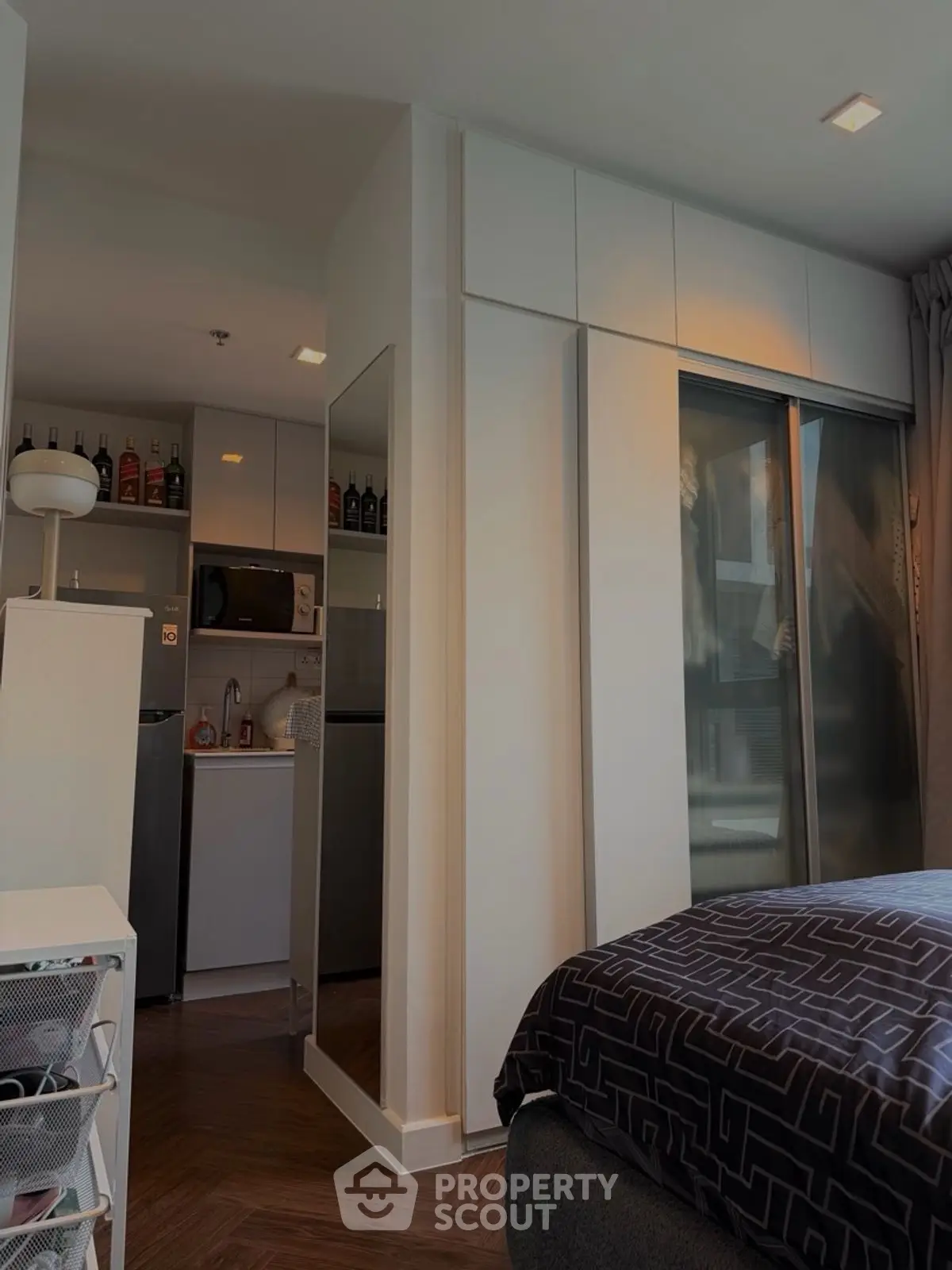 Modern compact apartment with sleek kitchen and cozy bedroom