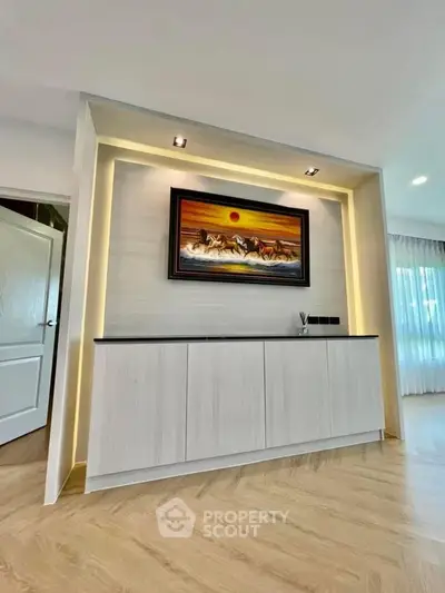 Modern living room with elegant wall art and ambient lighting