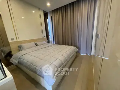Modern bedroom with elegant decor and cozy ambiance, featuring a comfortable bed and stylish curtains.