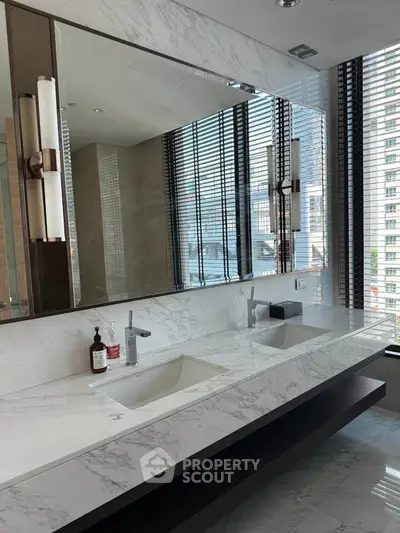 Luxurious modern bathroom with marble countertops and dual sinks in high-rise apartment.