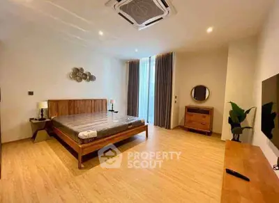 Spacious modern bedroom with wooden flooring and elegant decor