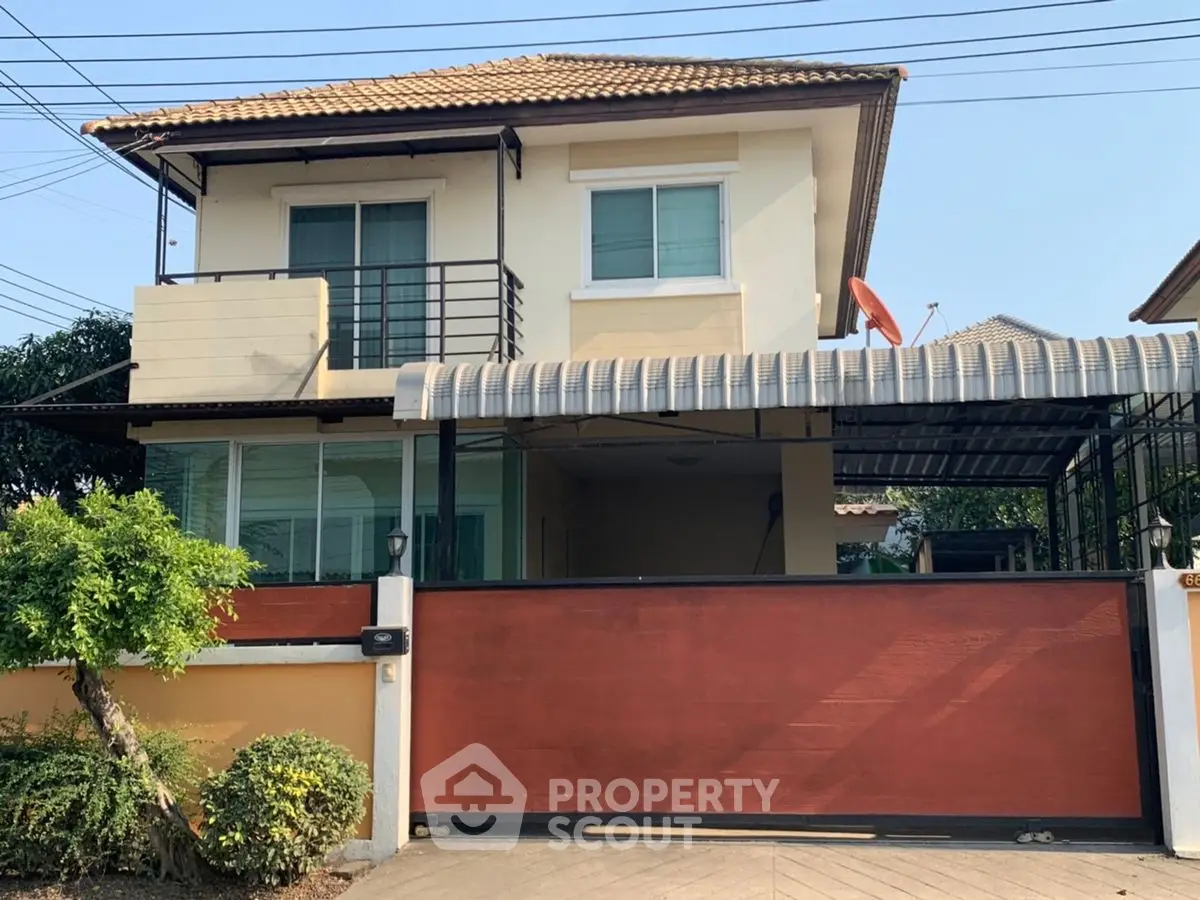 Charming two-story house with gated entrance and covered carport in a serene neighborhood.