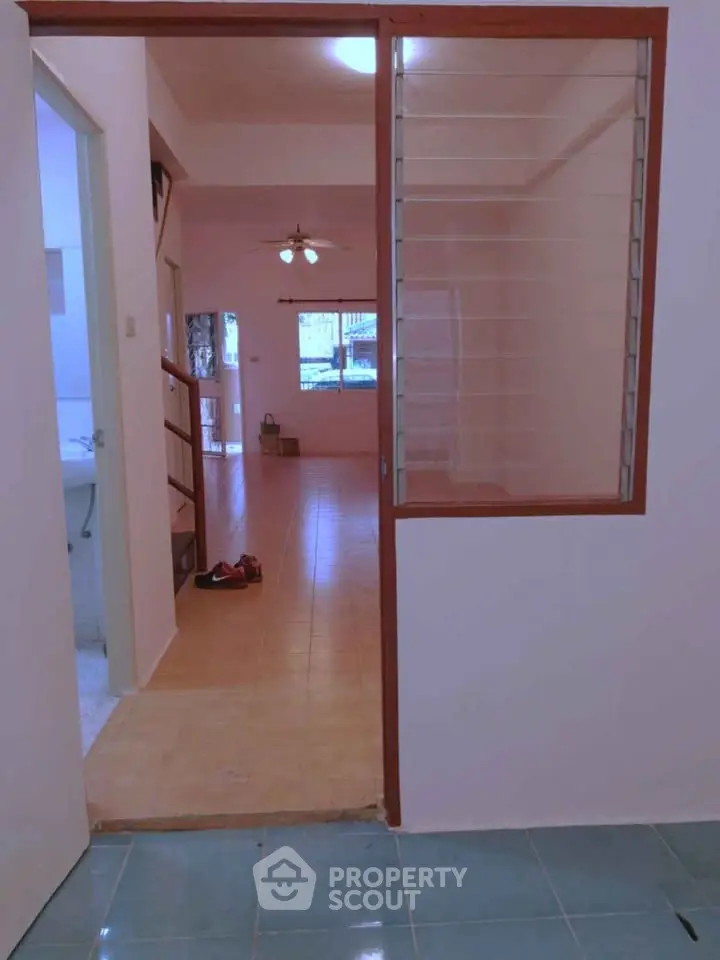 Spacious interior with tiled floors and ceiling fan, ideal for comfortable living.