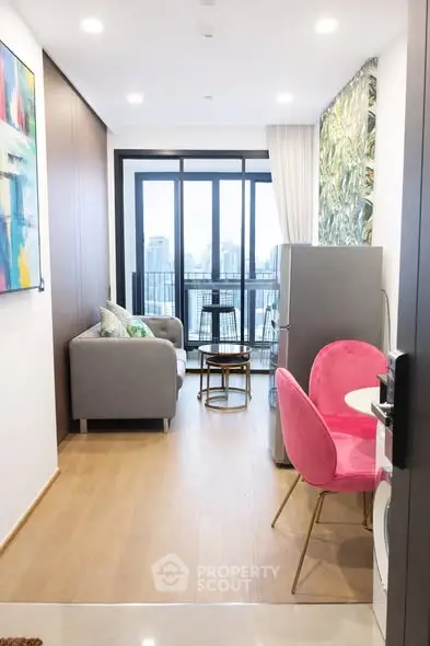 Modern living room with city view, stylish decor, and open layout in urban apartment.