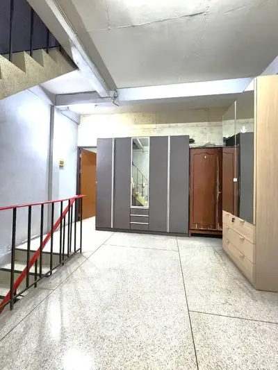 Spacious interior area with wardrobes and staircase, ideal for storage or creative use.