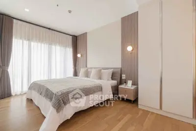 Elegant bedroom with modern decor and large window for natural light