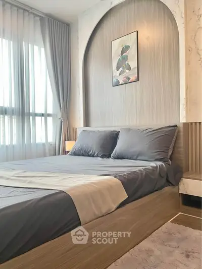 Elegant bedroom with modern decor and large window for natural light