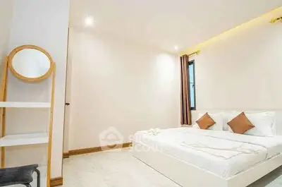 Modern minimalist bedroom with cozy lighting and stylish decor.