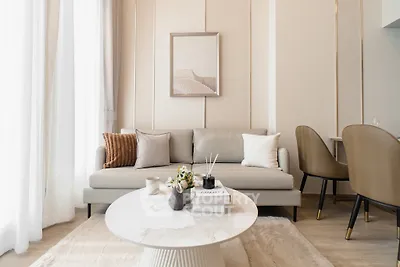 Modern living room with elegant decor, neutral tones, and stylish furniture, perfect for contemporary living.