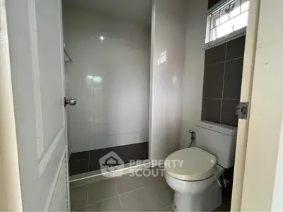 Modern bathroom with sleek design and tiled shower area, perfect for a contemporary home.