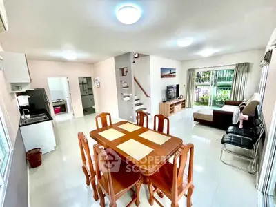 Spacious open-plan living and dining area with modern furnishings and natural light.