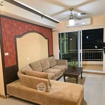 Spacious living room with modern sofa and balcony access in a stylish apartment.