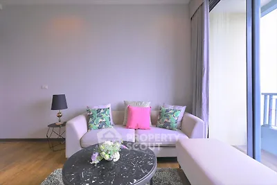 Stylish living room with modern decor and balcony view, perfect for urban living.