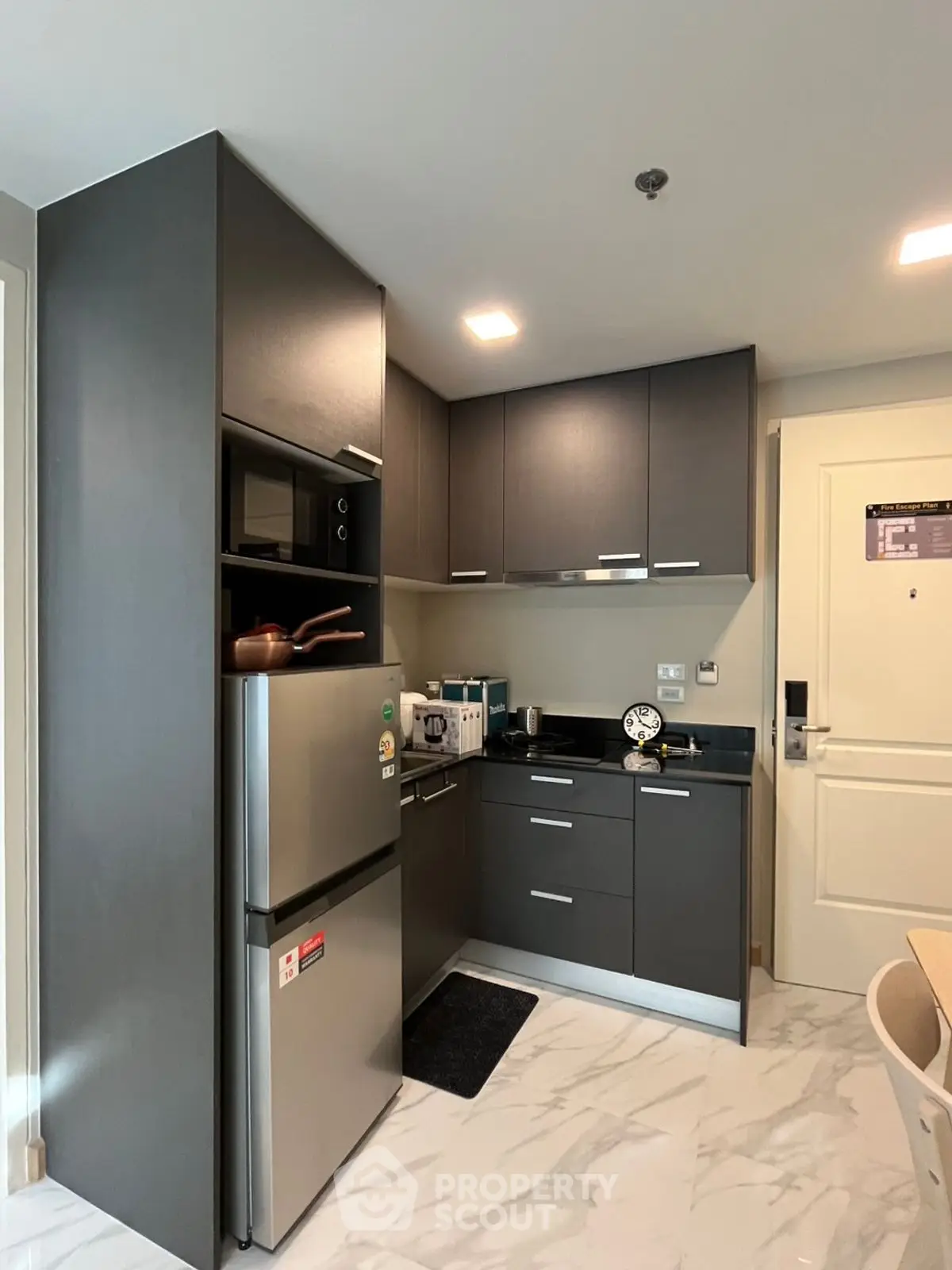 Modern kitchen with sleek cabinetry and stainless steel appliances in a compact layout.