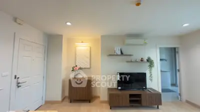 Modern living room with stylish furniture and wall-mounted TV, perfect for cozy gatherings.