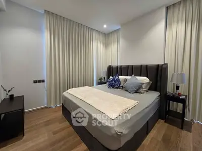 Elegant bedroom with modern decor and cozy ambiance, featuring a plush bed and stylish furnishings.