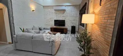 Cozy living room with modern decor and exposed brick walls