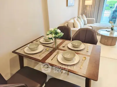 Elegant dining area with modern table setting and cozy living room view
