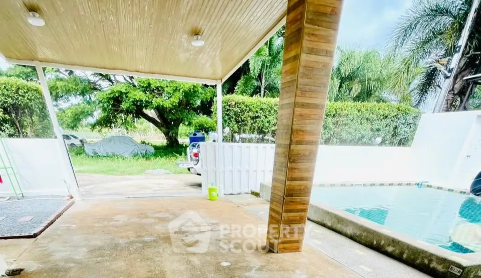 Spacious outdoor area with pool and lush greenery, perfect for relaxation and entertaining.