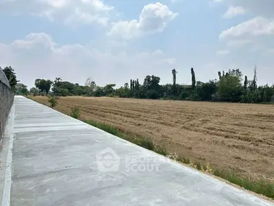 Expansive land plot with clear skies, ideal for development or agriculture.