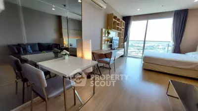 Modern studio apartment with open layout, featuring a cozy living area, dining space, and large window with city view.