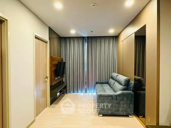 Modern living room with sleek design, cozy sofa, and wall-mounted TV, perfect for relaxation and entertainment.