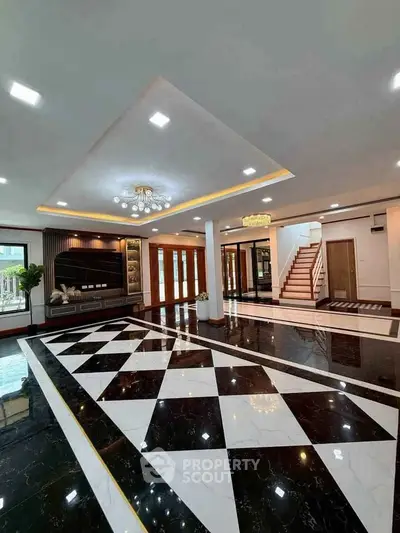 Luxurious modern living room with elegant black and white marble flooring and stylish lighting.