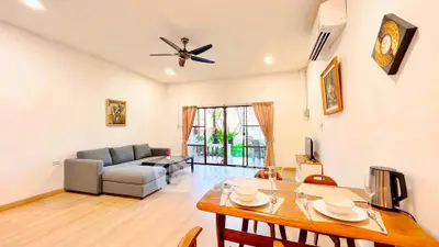 Spacious living room with modern decor and balcony access