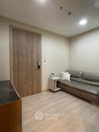 Cozy living room with modern sofa and wooden door, perfect for relaxation.